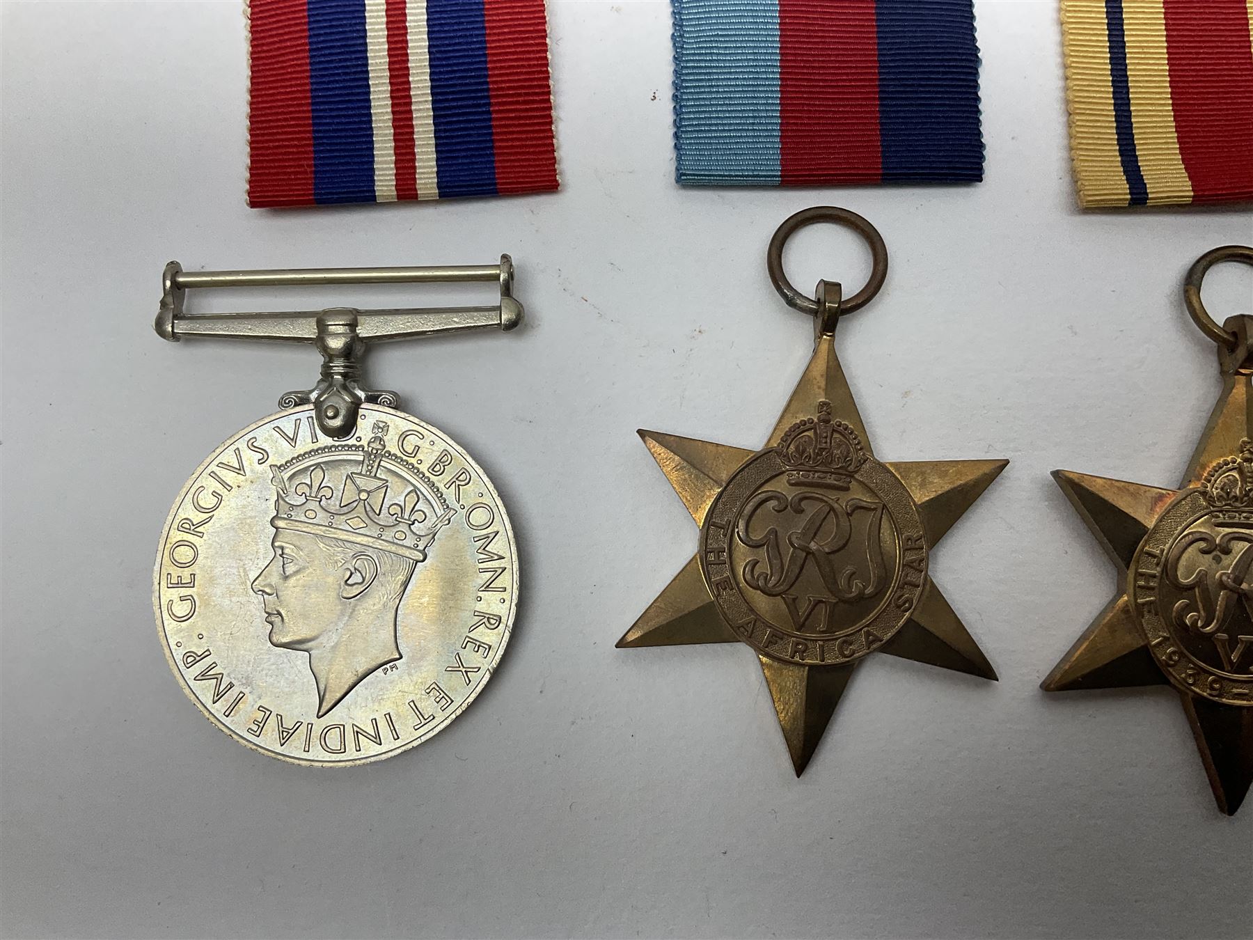 Twelve WW2 medals comprising four 1939-1945 war medals, four Defence medals, three 1939-1945 Stars and Africa Star; all with ribbons; some as groups in two issue boxes with slips