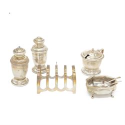1930s three piece silver cruet set, comprising mustard pot with cover, salt and pepper shakers, together with 1960s toast rack and open salt, both hallmarked 