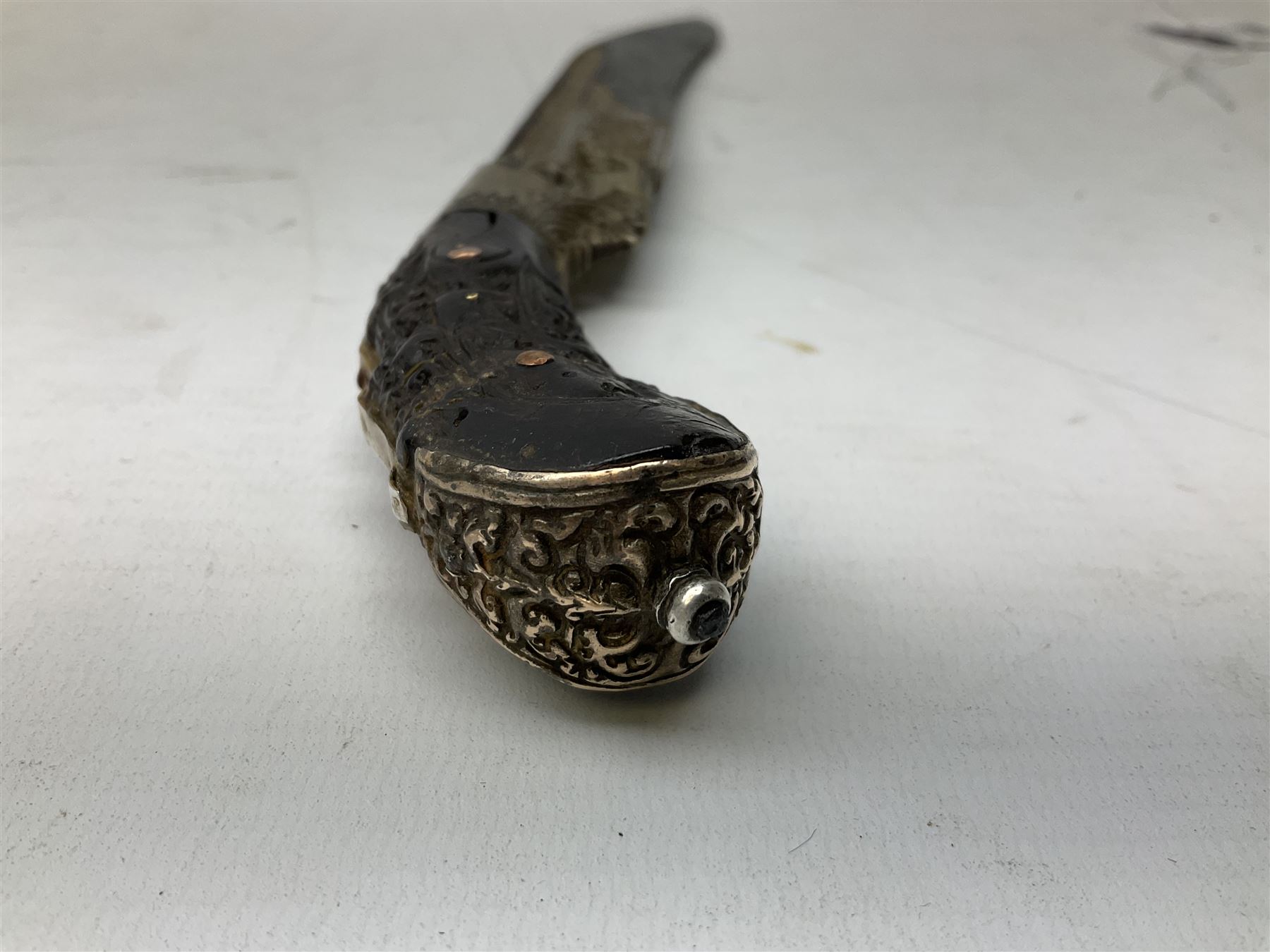 19th century Singhalese knife pia kaetta, the 20cm steel blade inset with yellow and white metal, with metal mounted carved pistol grip, in plain wooden scabbard L33cm overall