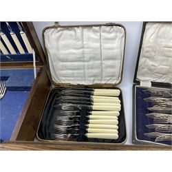 Six canteens of fish knives and forks, including a set of six crusade fish knives and forks with faux ivory handles 