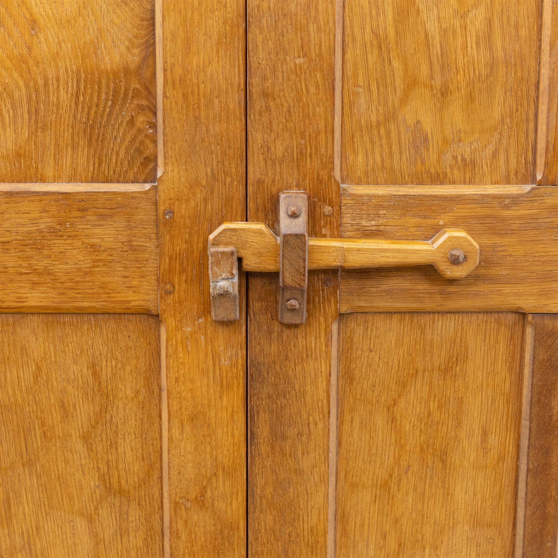 Acornman - oak adzed panelled double wardrobe, with wrought iron hinges and carved oak latch revealing a single clothes rail, with signature carved acorn to top left, by the workshop of Alan Grainger, Brandsby