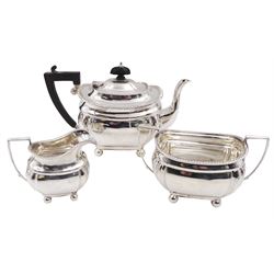 1920s silver three piece bachelors tea service, comprising teapot, cream jug and twin handled open sucrier, each of bellied form with oblique gadrooned rim, upon four bun feet, the teapot with Bakelite type handle and finial, hallmarked Thomas Edward Atkins, Birmingham 1912, teapot H13.5cm