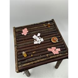 Anthropomorphic Taxidermy: Two red squirrels (Sciurus vulgaris), both seated upon a chair holding playing cards, one smoking a pipe 