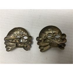Two WW2 German 'SS' visor cap skull badges and another later; and visor cap eagle insignia (4)