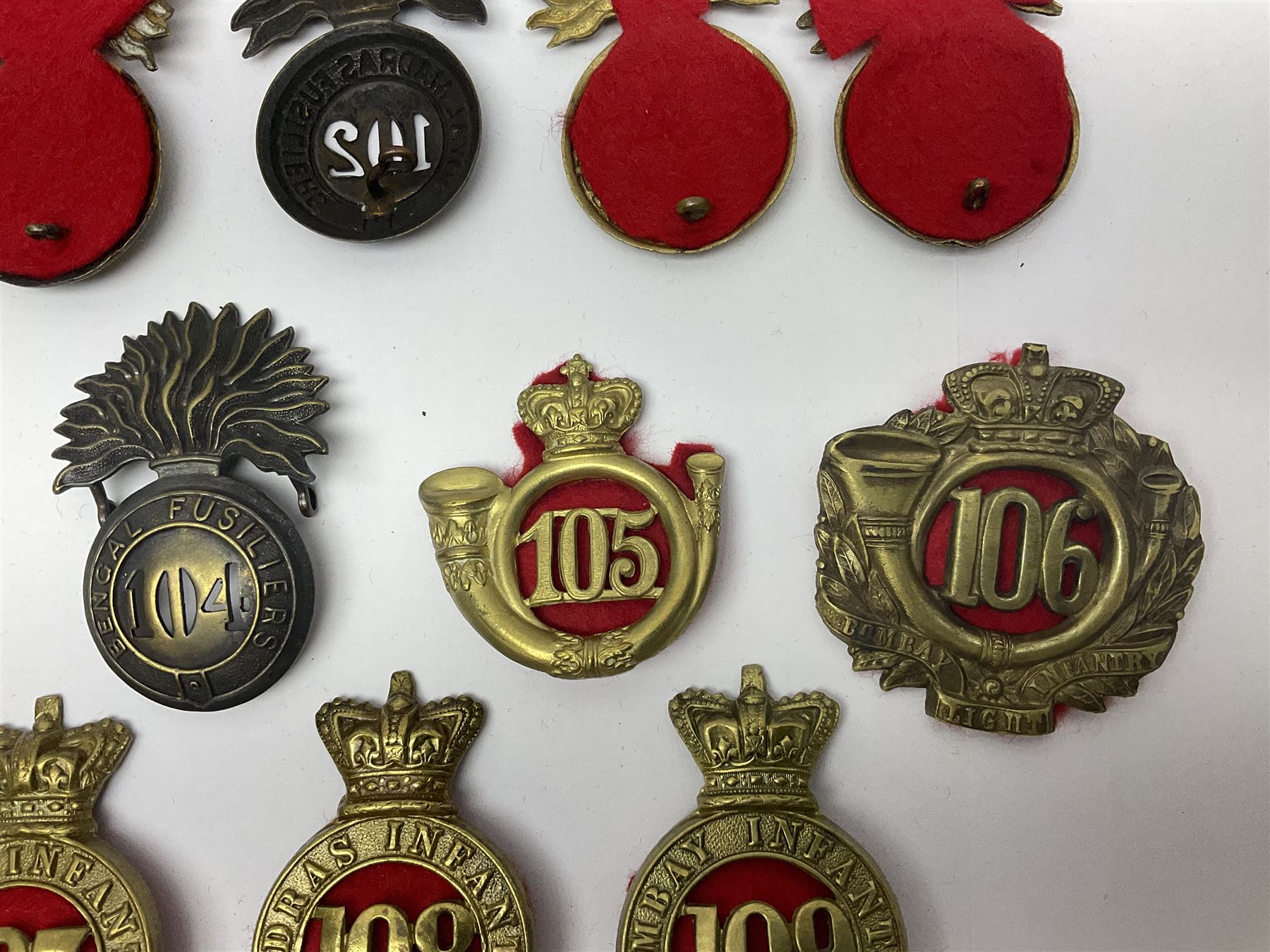 Ten cap badges of Indian interest comprising Bengal Fusiliers No.104, Bengal Infantry No.107, Royal Bengal Fusiliers No.101, Bombay Infantry No.109, Bombay L.I. No.106, two Royal Madras Fusiliers No.102, Madras Infantry No.108 and Madras L.I. No.105 (10)