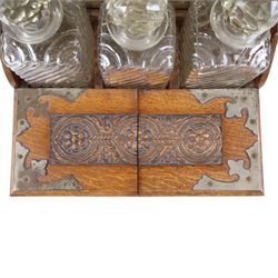 Victorian brass mounted oak tantalus, containing a set of three decanters, fitted with a games compendium to the front, H32cm