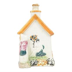 19th Century Staffordshire pearlware Prattware type money box, modelled as a houe with two figures to the front corners, H13cm