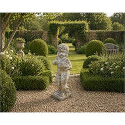 Early composition stone figure of a boy with grape basket, original flakey white paint