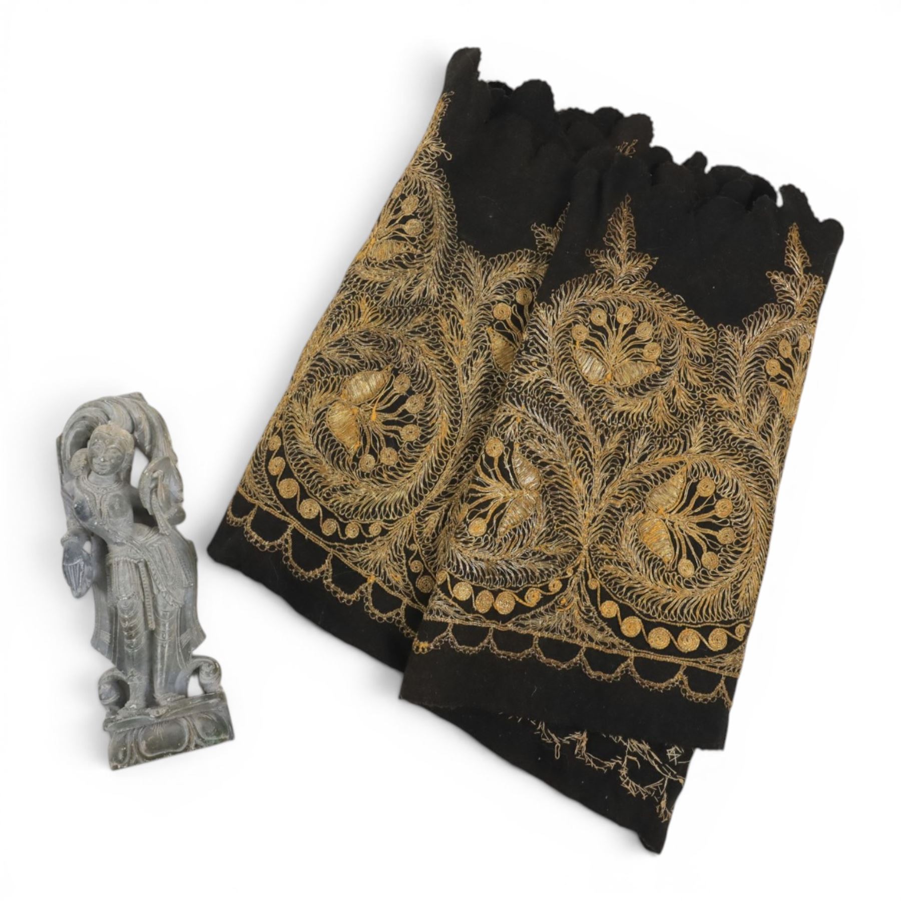 Stone carving of goddess, together with material with gold thread decorated with stylised flowers 