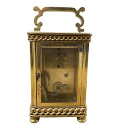 French- Edwardian 8-day carriage clock c1910, with recessed chain decoration and a serpentine handle, four recessed glass panels raised on bun feet, decorative enamel dial with floral swags, Arabic numerals and matching steel hands, single train movement with a cylinder platform escapement. With key.