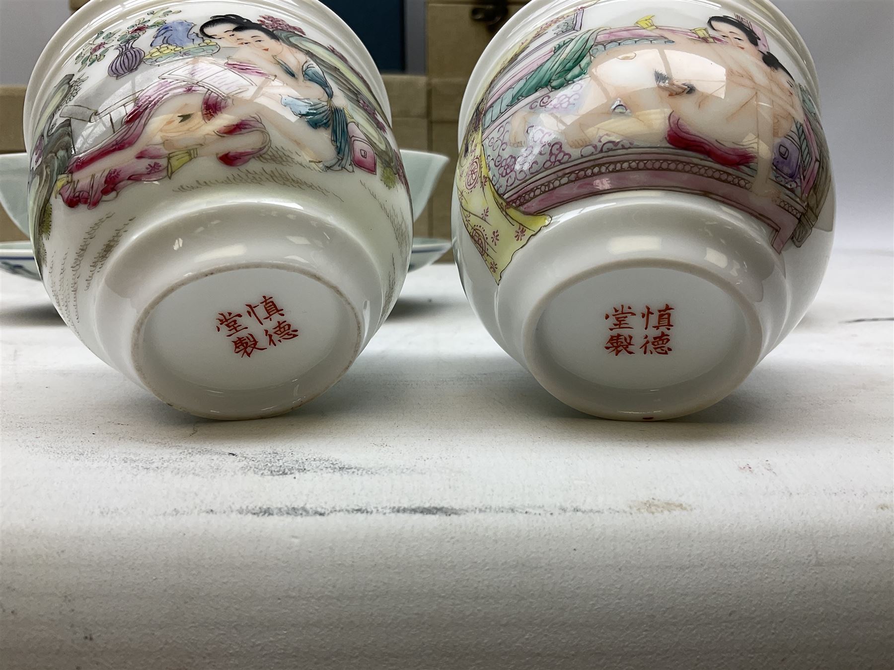 Two Chinese Yixing teapots, Chinese tea bowl hand painted with figures reading, another tea bowl with with underglaze floral panel and another tea bowl with saucer and lid, together with other teacups etc all boxed and with character marks