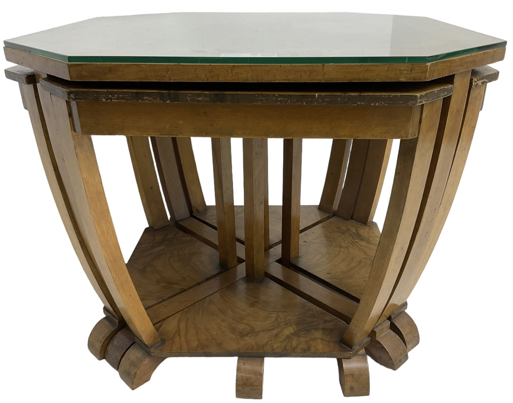 1930s Art Deco period walnut nest of tables, square canted top with segmental figured veneers forming flowerhead with birdseye maple centre, with four smaller nesting tables on arched supports united by undertier, on block feet