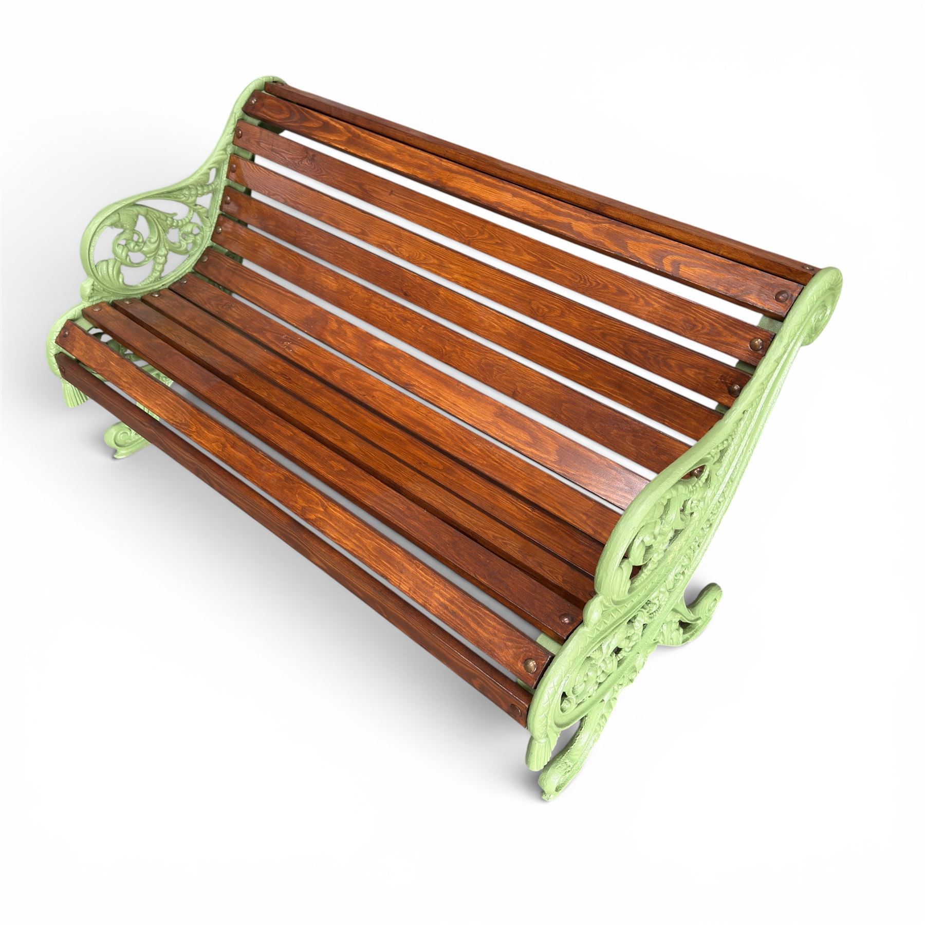 Pair of Victorian design cast iron and slatted wooden garden benches, the ornate pierced end supports of scrolled form, the pierced acanthus leaves interspersed with trailing flowerheads, with tassels to the front, raised on splayed feet, the supports in pale sage green painted finish