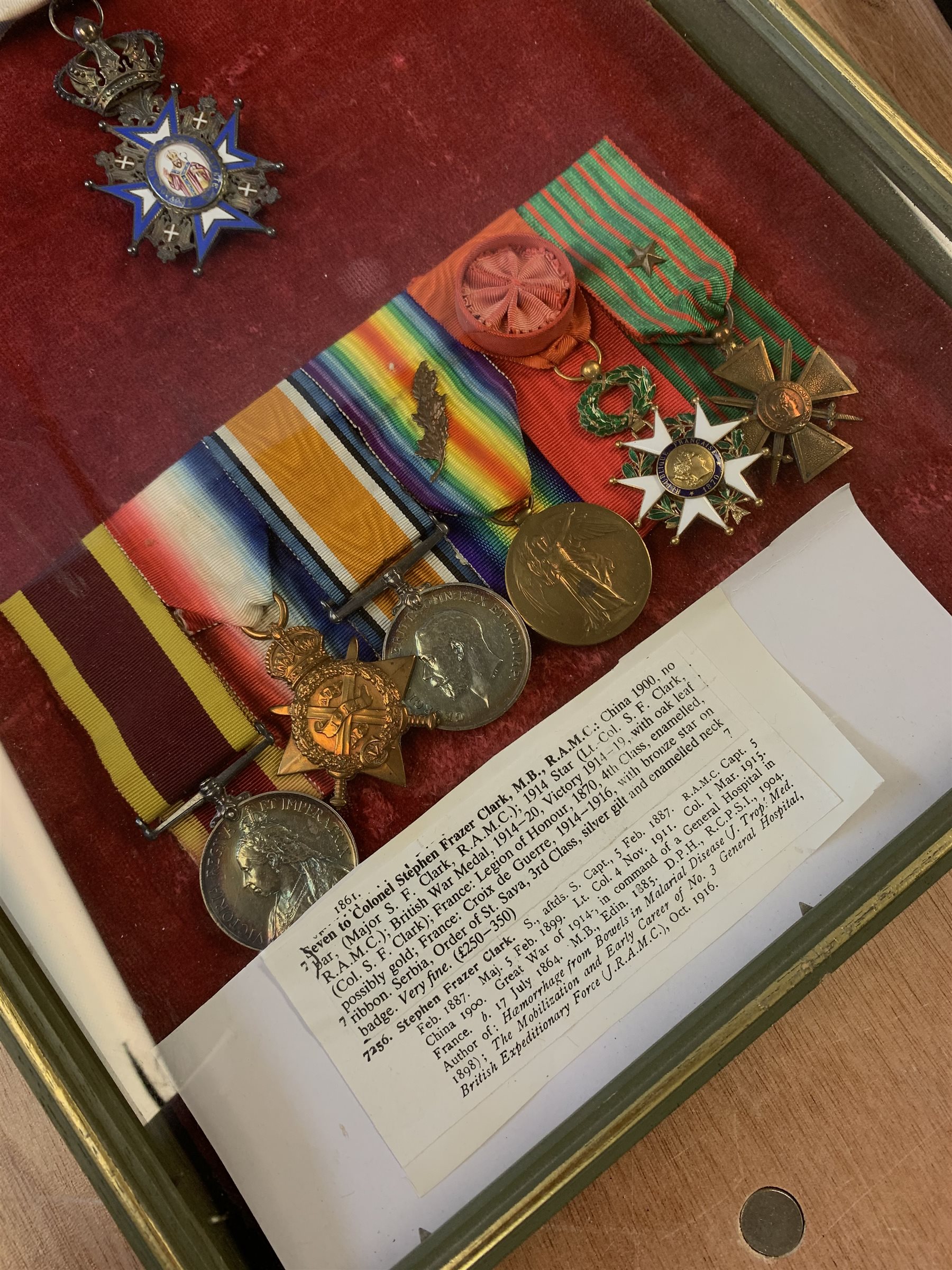 Group of seven medals/awards to Col. Stephen Fraser Clark M.B. R.A.M.C. comprising Victoria China 1900, no bar (Major S.F. Clark R.A.M.C.); 1914 Star (Lt.-Col. S.F. Clark R.A.M.C.); British War Medal 1914-20 and Victory Medal 1914-19 with oak leaf (Col. S.F. Clark); French Legion of Honour 1870 4th class enamelled; French Croix de Guerre 1914 -1916 with bronze star on ribbon; and Serbian Order of St. Sava 3rd Class silver gilt and enamelled neck badge; framed with some biographical information