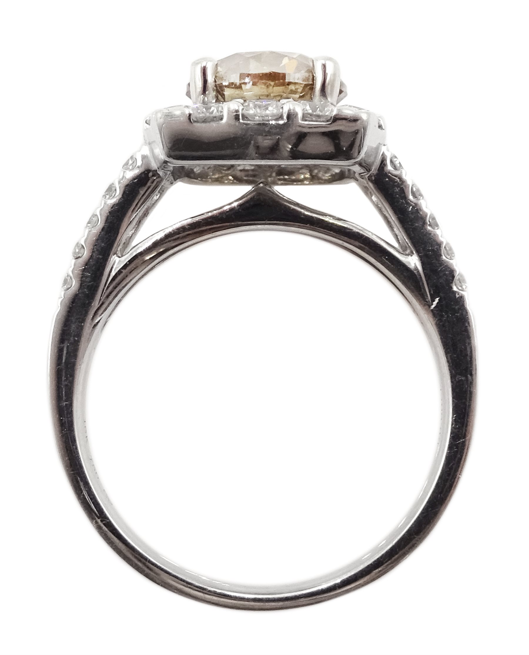 18ct white gold round brilliant cut fancy light brown diamond ring, with halo diamond surround and diamond set shoulders, stamped 750 18K, central diamond 2.00 carat, total white diamond weight 0.90ct