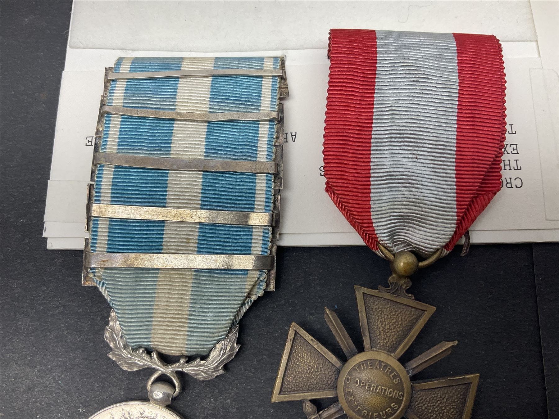 French Republic Colonial Medal with five clasps for Libye, Afrique Francaise Libre, Bir Hakeim, Koufra and Tchad; and Croix de Guerre Des Theatres D'Operations Exterieurs with three MID leaves and gold star; both with ribbons (2)