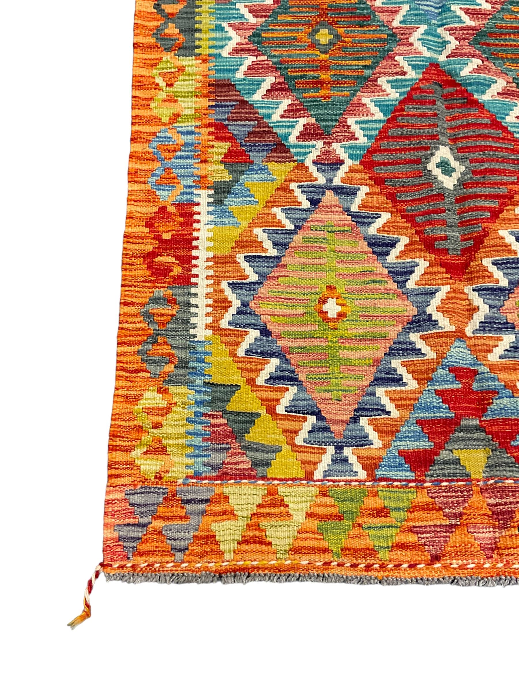 Chobi Kilim rug, multi-coloured ground in oranges, blues and greens, overall geometric design 
