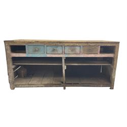 Early 20th century rustic pine workman's bench, rectangular top over four blue painted drawers, under-tier to base, raised on stile supports