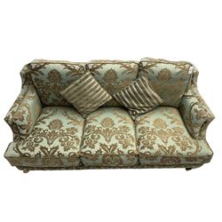 Wade - 'Kempston' three seat sofa, upholstered in chenille fabric with brocade pattern, raised on mahogany finish square tapering block feet with heavy brass castors