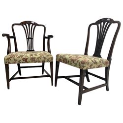 George III Hepplewhite design mahogany elbow chair and matching side chair, cresting rail carved with bellflowers over pierced and flared splat, seats upholstered in floral patterned fabric, raised on square tapering supports united by stretchers