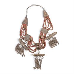 Collection of Middle Eastern jewellery, including silvered multi strand necklace with beadwork and filigree decoration with three cylindrical pendants, pendant necklace with central orange cabochon, beadwork choker and similar  