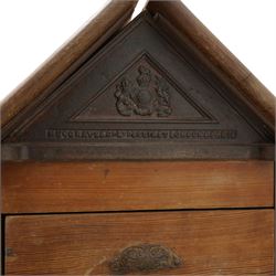 Musgrave & Co Ltd (Belfast) - late 19th century pine saddle horse, with three drawers to one end and cupboard door to the other, the hinged top opening to form a table, the cast iron plaque bears the Royal coat of arms and maker's name