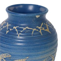 Quentin Bell 1910-1996: ribbed vase with fluted rim, decorated in white abstract design on a blue ground, signed Bell beneath, H16cm 