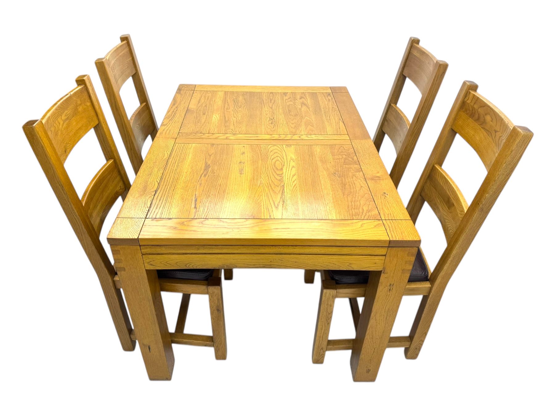Contemporary oak dining table, rectangular panelled top with integral extension leaf, raised on square supports; set of four oak ladder-back chairs with padded brown seats