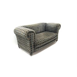 Early 20th century two seater drop arm sofa, upholstered in geometric pattern, turned supports and castors 