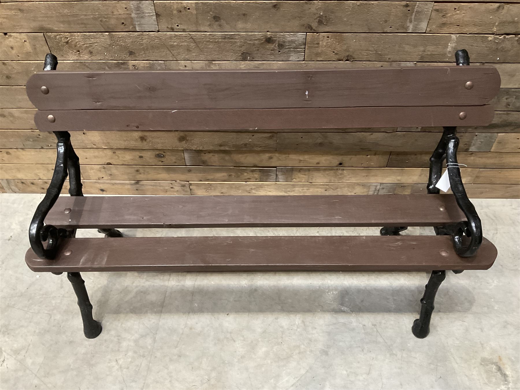 20th century tree cast iron and timber slatted garden bench, black painted frame with stained wood