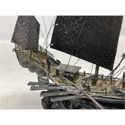 Chinese miniature silver model of a junk ship, with textured sails, mounted upon a carved wooden stand, H14cm