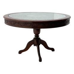 Pakistan carved hardwood brass inlaid circular dining table, and four rail back chairs with saddle seats