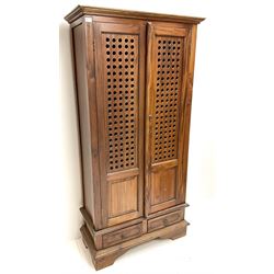 Eastern hardwood bookcase, projecting colonies, two doors enclosing three shelves above two drawers, shaped bracket supports