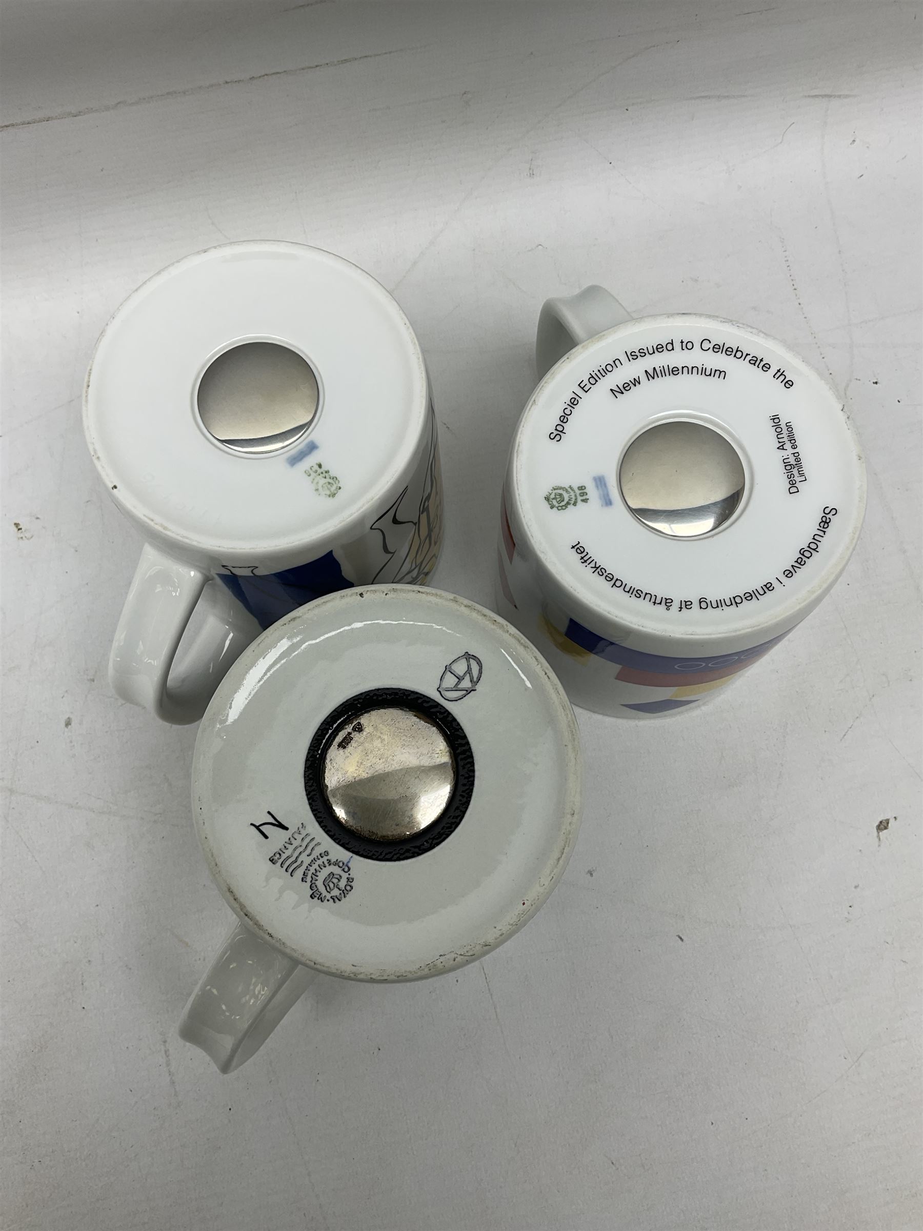 Set of three Royal Copenhagen year mugs, comprising 1976 with silver plaque stamped 925 beneath, and two 2000 examples, H11.5cm