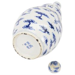 Chinese Kangxi style double-gourd form vase, the blue and white vase surmounted by a domed cover, decorated with dragons chasing a flaming pearl, four-character mark to beneath, H31cm