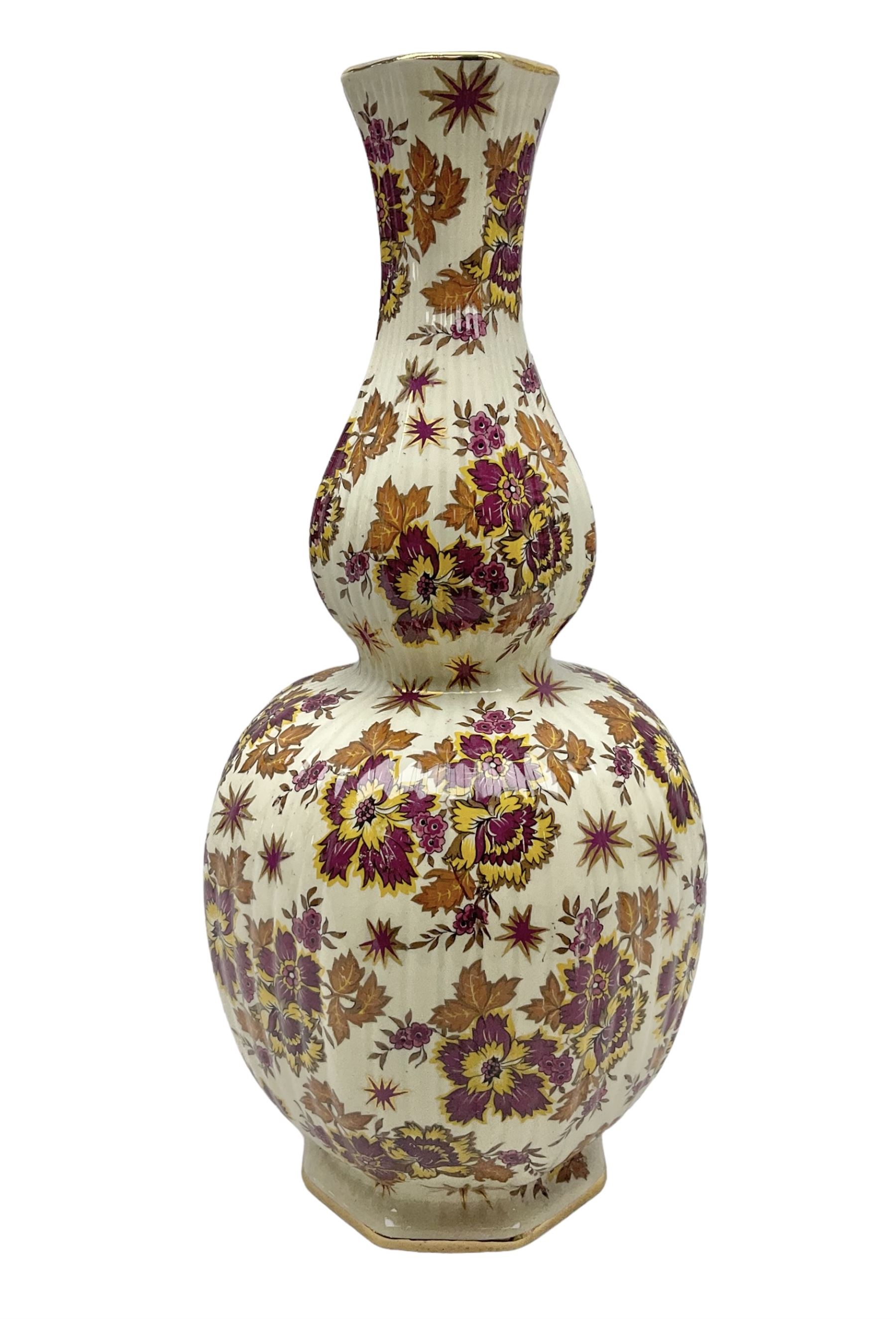Mid 20th century Boch Freres of Belgium Keralux Fleur De Saxe vase, of double gourd form with pink and yellow flowers amongst orange foliage and gilt decoration, H44cm