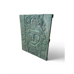 Pair of South East Asian carved wooden panels, depicting Buddha or Deity faces