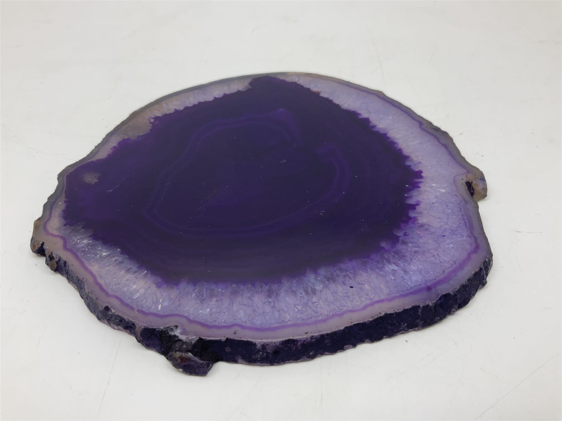 Pair of purple agate slices, polished with rough edges, raised upon gilt metal stands