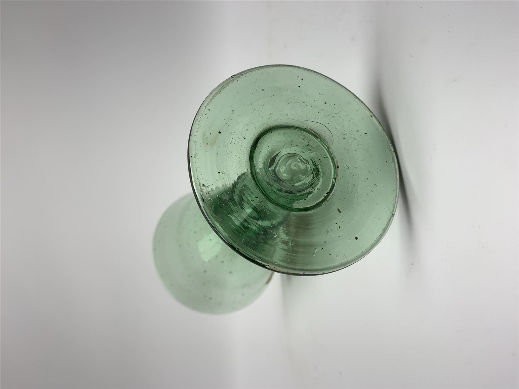 19th century bohemian green glass wine glass, the funnel bowl decorated in enamells with a Historismus hunting scene in the manner of Egermann & Lobmeyr, upon a baluster stem and circular foot, H14.5cm