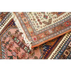 Persian Iranian wool runner, with a series of stepped hexagonal medallions in rust, olive and ivory against and deep navy field, the medallions are filed with floral and latch-hook motifs, framed by and ivory guard border with geometric rosettes, flanked by a rust outer band