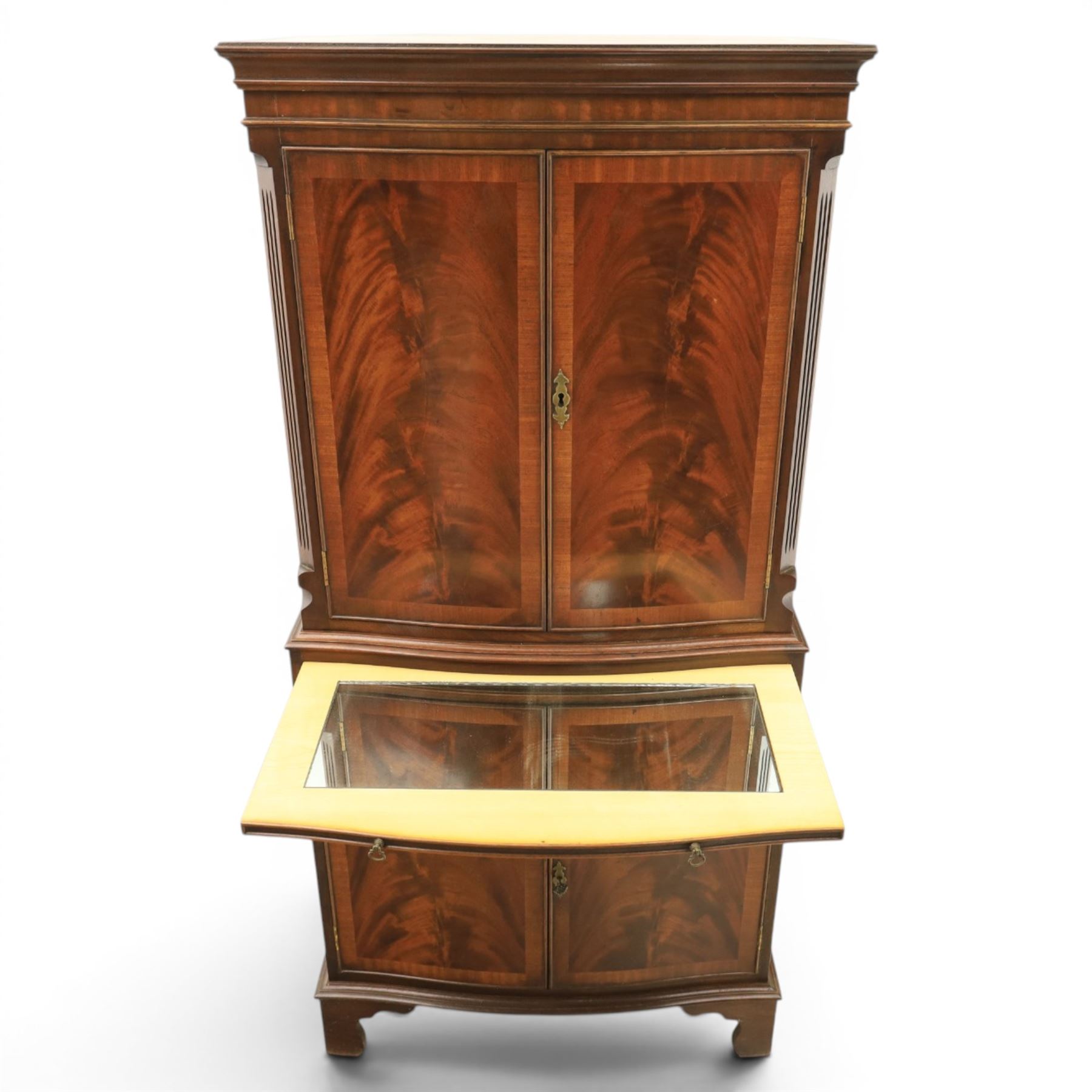 Georgian design mahogany cocktail drinks cabinet, bow fronted with mirrored and maple interior, slide out mirrored serving area, over two drawers and a cabinet below, raised on bracket feet