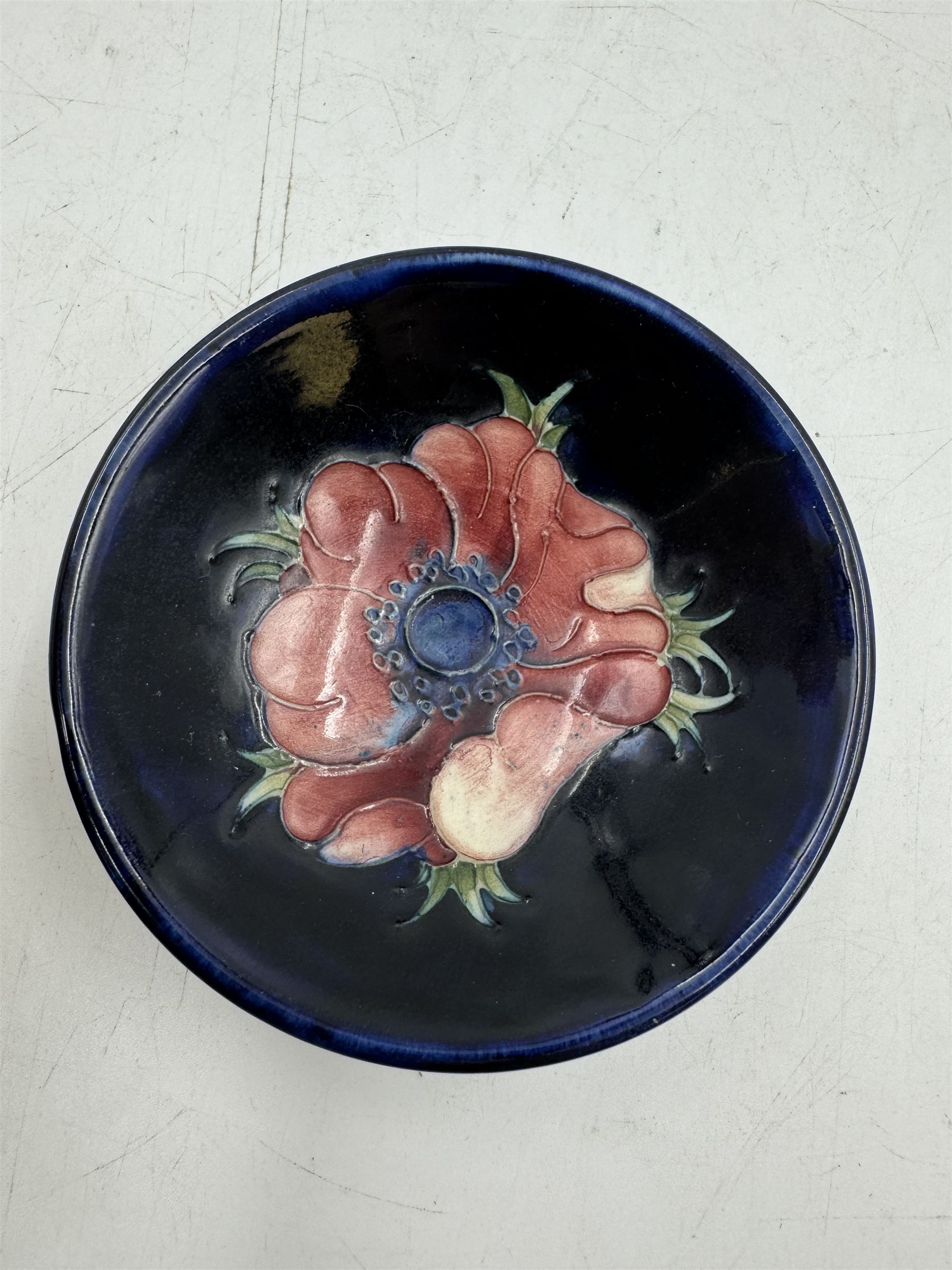 Moorcroft pewter-mounted circular ashtray decorated in Pomegranate pattern, together with Anemone pattern ashtray and trinket dish, all with makers mark beneath    