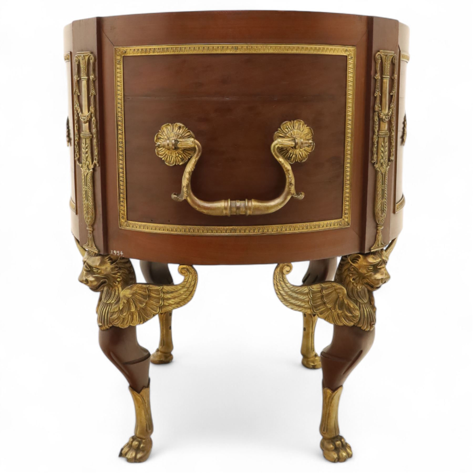 An imposing and richly adorned Empire Revival jardiniere of circular form, decorated with finely cast gilt bronze laurel garlands and floral swags, interior with a modern brass liner, sides with gilt bronze carrying handles, raised on three tripod legs with classical caryatid masks with wings terminating in lion paw feet, circa 1900

Provenance: This jardiniere formed part of the original furnishings of the opulent Empire Room at Kinloch Castle, built by industrialist George Bullough in 1900.

An original inventory number, ‘X954’, is inscribed on one facing, verifying its presence in the Kinloch Castle collection. This jardiniere epitomises the lavish taste of the Edwardian elite and the high standards of craftsmanship employed in the furnishing of Kinloch Castle, the first private home in Scotland to be lit by electricity and famed for its extravagant interiors.


