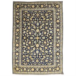 Central Persian Kashan hand-knotted carpet, deep indigo field with a densely all-over arra...
