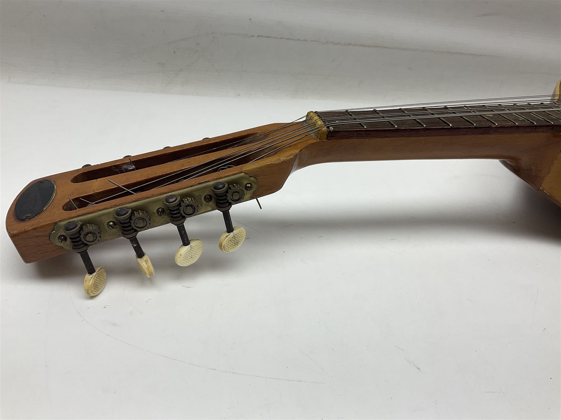 Italian eight-string mandolin with maple back and ribs and spruce top with inlaid floral marquetry panel within a fragmented mother-of-pearl border L61cm; cased; and a (damaged) German 'Michigan' mandolin for spares or repair (2)