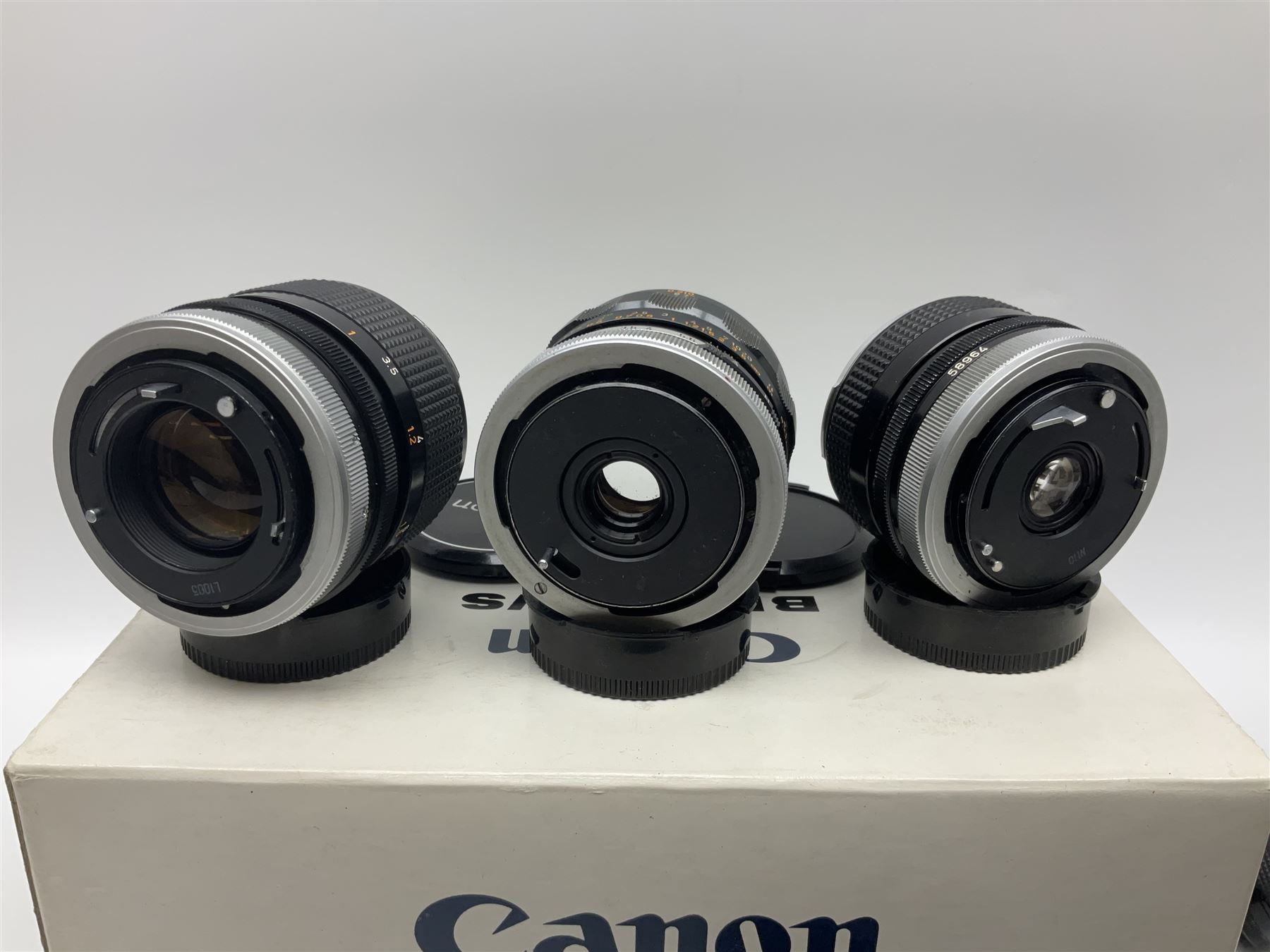 Collection of Canon lenses, to include 'Canon Lens FD 100mm 1:2.8', serial no 12821, 'Canon Lens FD 200mm 1:4' serial no 245313, 'Macro Canon Lens FL 50mm 1:3.5', serial no. 25505, 'Canon Lens FD 135mm 1:3.5 etc, together with other Canon equipment, including Bellows FL, Slide Duplicator etc 