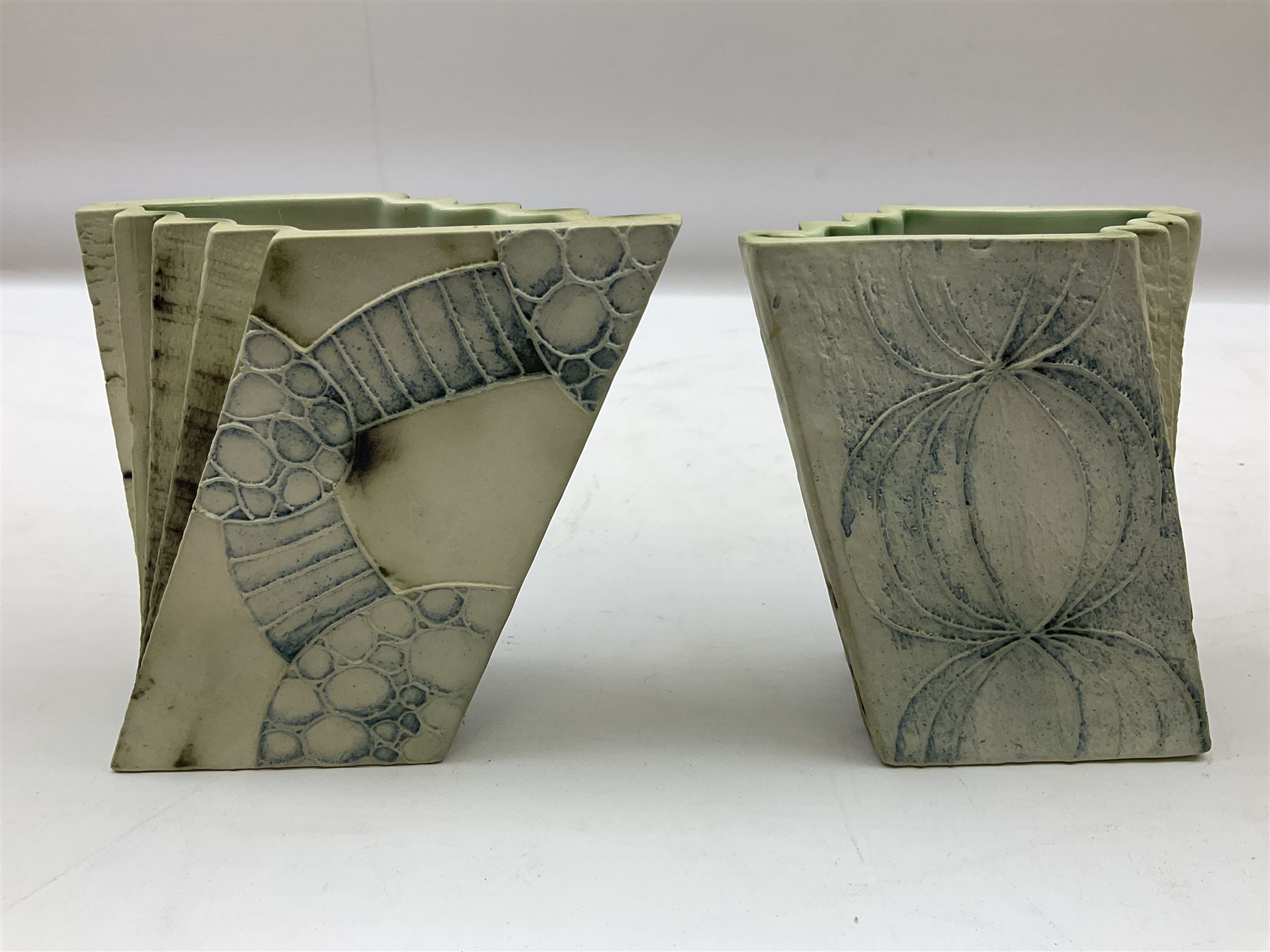 Pair of Carn Pottery Penzance vases of fan form, with tube lined floral and stylised decoration, stamped and marked X9 to base, H11.5cm