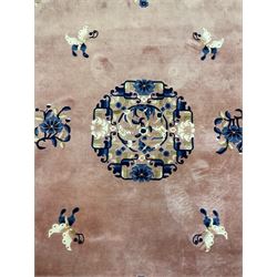 Chinese woollen rug, blue and light pink ground, decorated with flower and butterfly motifs