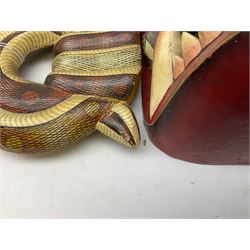 Sri Lankan Cobra mask depicting the demon Naga Raksha, together with a smaller example, largest H46cm