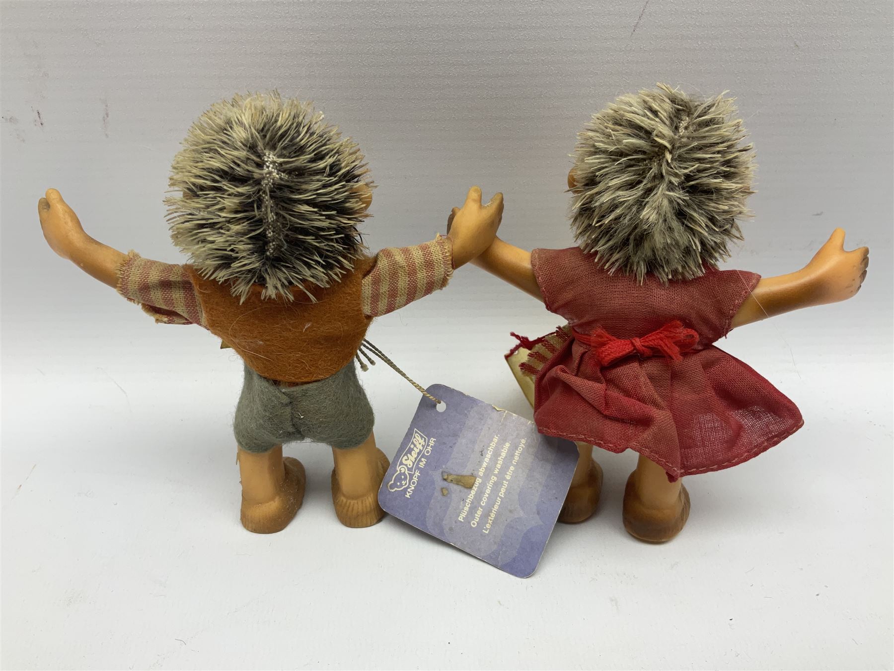 Group of Steiff figures, comprising Mikki and Mukki, circa 1950s no 7628/12 and 7627/12, with original tags, two hedgehogs no 1570/10, and another smaller 1670/03, small owl no 7480/06, and painted metal Steiff harlequin style bear